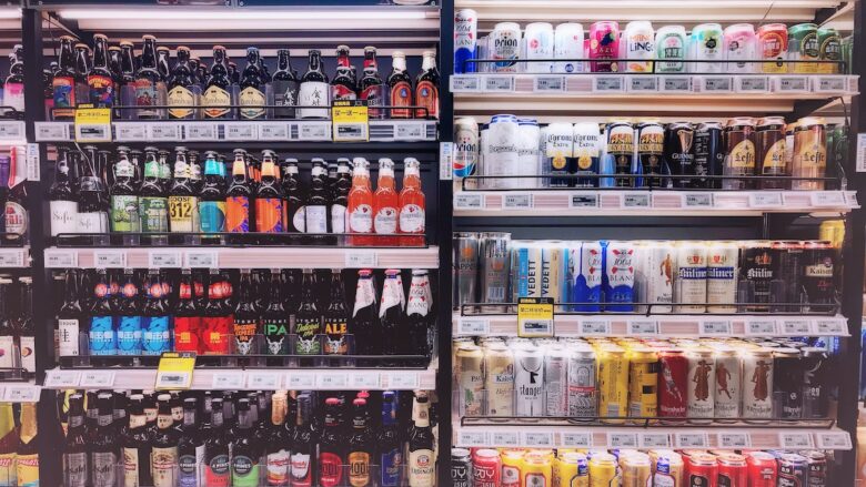 A row of beer bottles in a store.